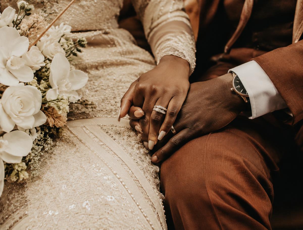 A newlywed couple holding hands after their ceremony